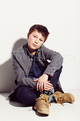 Buy stock photo Young adolescent boy sitting against a white background