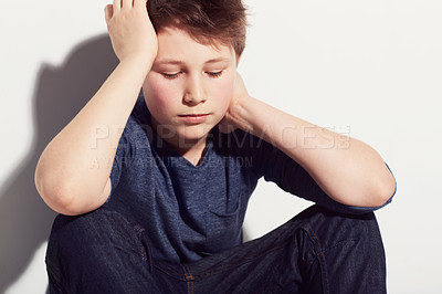 Buy stock photo Sad, teenager and boy thinking in studio or sitting in white background with anxiety from fail in school. Mental health, stress and kid with worry from mistake or depressed emotions and ideas