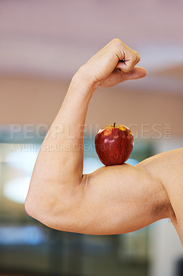 Buy stock photo Muscular man balancing an apple on his bicep