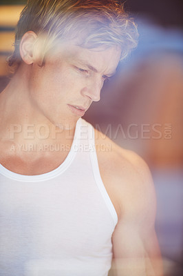 Buy stock photo Handsome blonde man looking through a window in contemplation