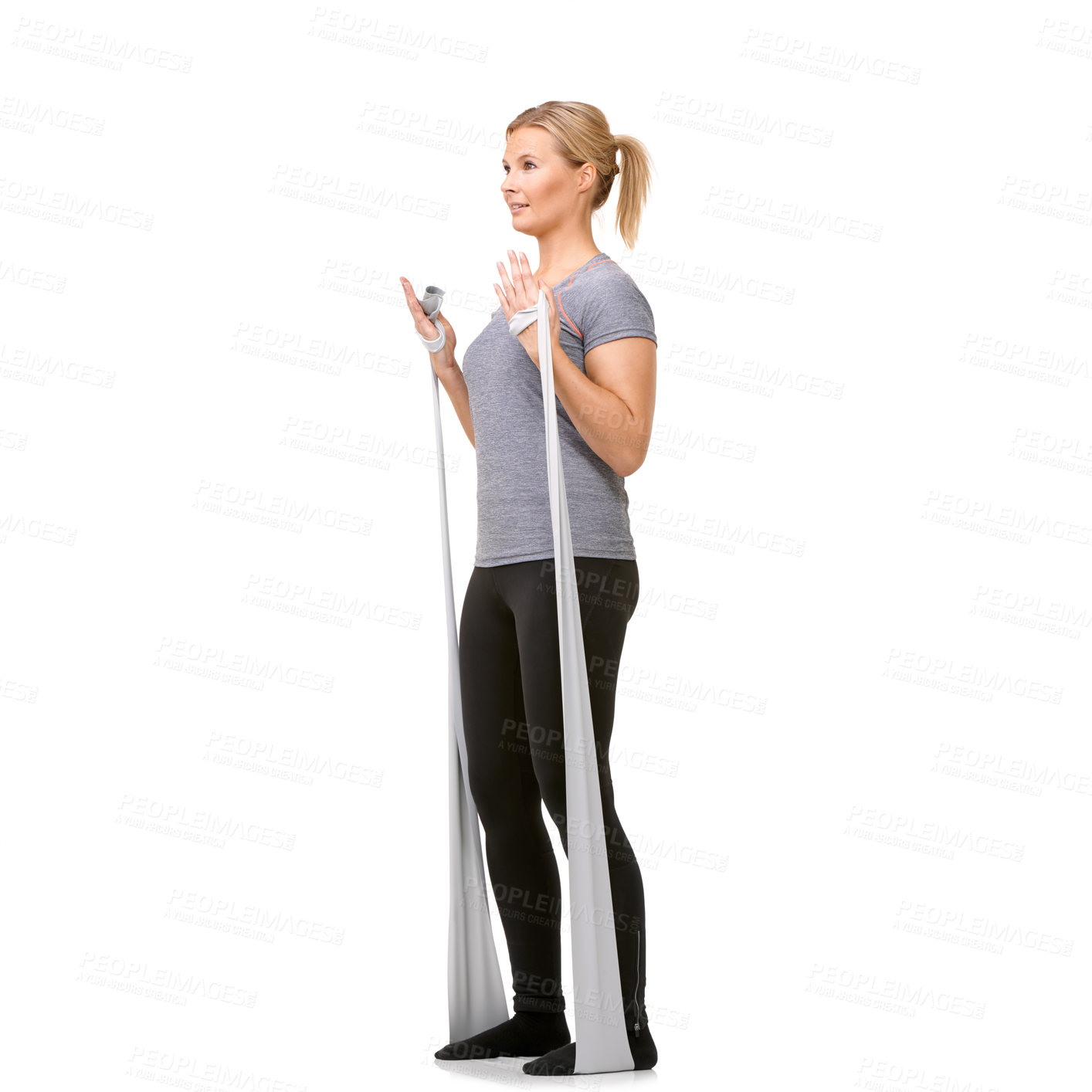 Buy stock photo A young blonde woman exercising with a resistance band - profile