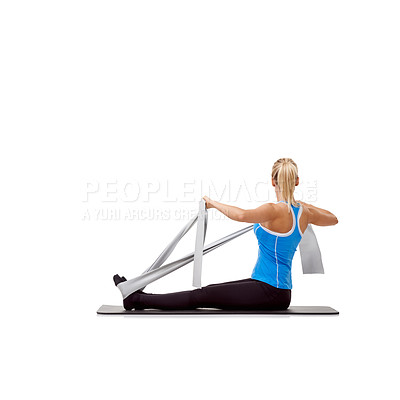 Buy stock photo Wellness, resistance band and woman doing exercise in studio for health, fitness and bodycare. Sport, yoga mat and young female person from Australia with arms workout or training by white background
