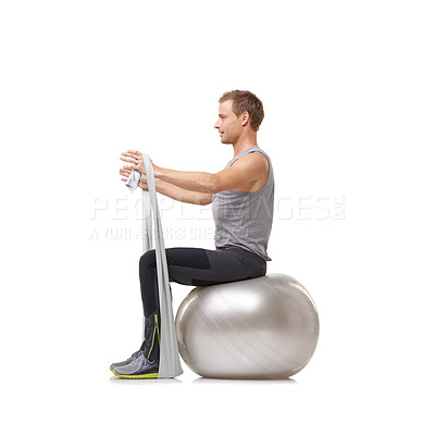 Buy stock photo Yoga ball, resistance band and man doing workout in studio for health, wellness and bodycare. Sport, fitness and young male person from Australia with arms exercise or training by white background.