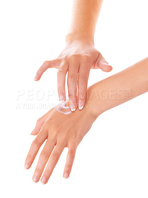 Buy stock photo Cropped shot of a woman applying lotion to her hands