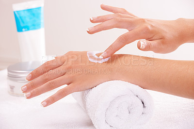 Buy stock photo Skincare, cream and hands closeup in spa, touch and massage on towel. Fingers, nails and woman apply lotion in treatment, natural cosmetics and dermatology moisturizer, beauty health and manicure
