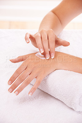 Buy stock photo Skin, apply cream and hands in spa, closeup and massage on towel for care. Touch fingers, nails and woman on lotion treatment, natural cosmetics or dermatology moisturizer, beauty health or manicure