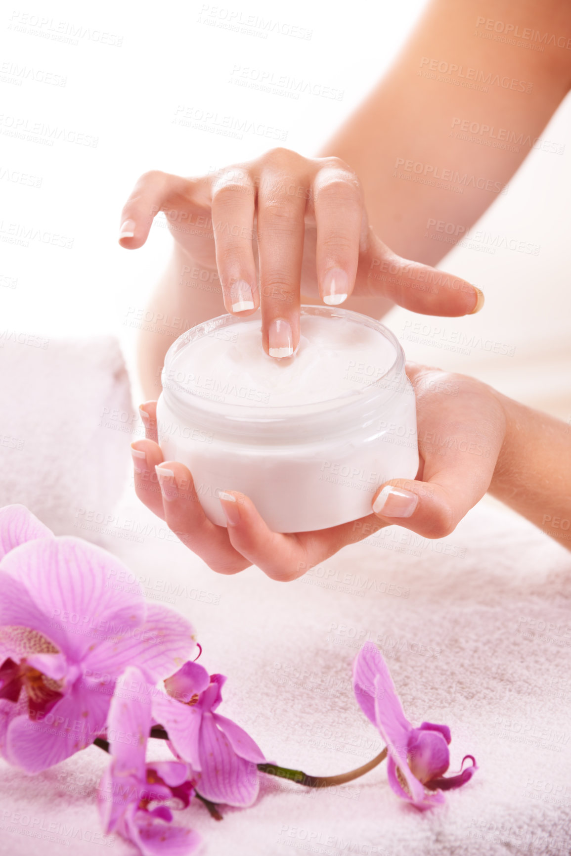 Buy stock photo Cropped shot of a woman holding a jar of hand cream