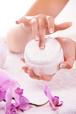 Buy stock photo Woman, hands and flowers with cream for skincare, cosmetics or beauty products in salon or spa treatment. Closeup of female person with jar or container of lotion, SPF or creme for skin moisturizer