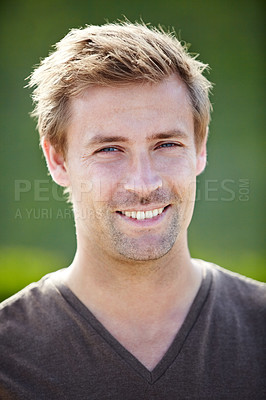 Buy stock photo A handsome young man smiling broadly at the camera