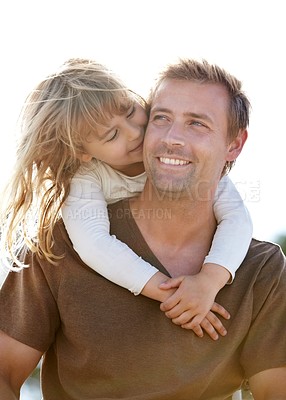 Buy stock photo A young father carrying his smiling daughter on his back
