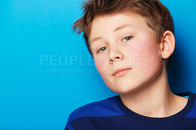 Buy stock photo Child, portrait and blue background with fashion, stylish youth and trendy clothes in a studio. Young boy, kid and face with confidence and student with modern and casual style with relax model