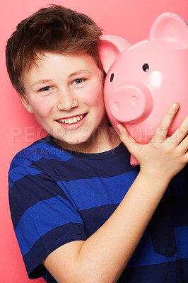 Buy stock photo Happy boy, portrait and piggy bank with smile for savings, money or coins against a pink studio background. Little child or kid holding piggybank and smiling for financial freedom, cash or investment