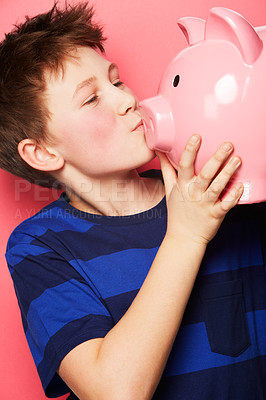 Buy stock photo Happy boy, savings and kiss on piggy bank for investment, money or coins against a pink studio background. Little child or kid holding and kissing piggybank for financial freedom, cash or growth