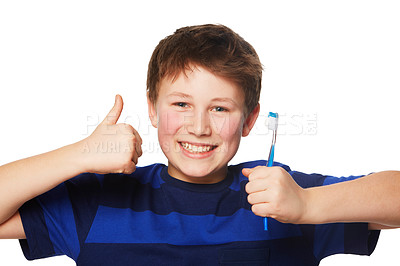 Buy stock photo Portrait of a young boy holding is toothbrush and giving a thumbs up