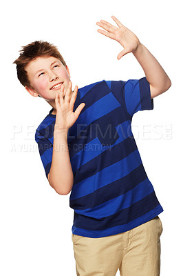 Buy stock photo Shock, hands raised and child with hiding, shield and protection looking up in a studio. Young boy, fashion and modern clothing with youth and scared from mockup with white background with kid