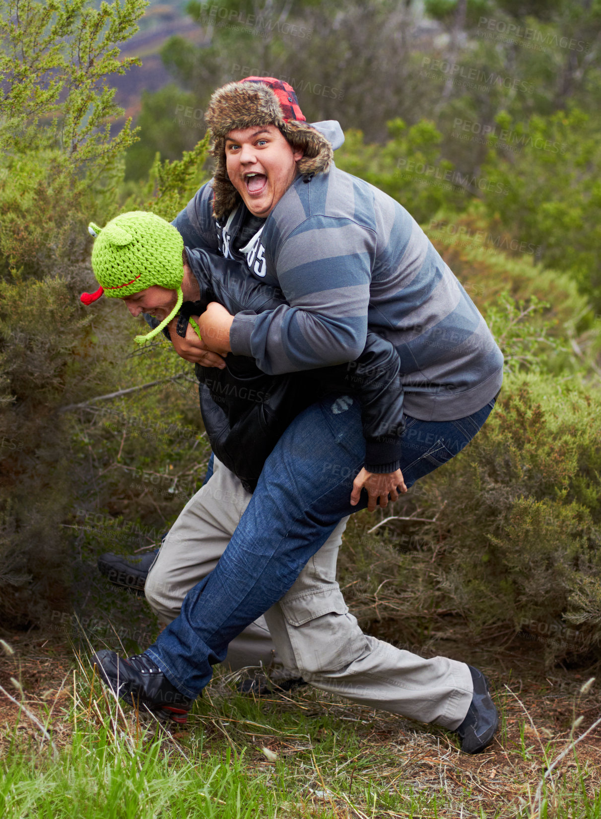 Buy stock photo Piggy back, fun and man friends outdoor camping in nature playing and having fun together. Happy, smile and silly portrait of youth and men laughing in the forest on summer camp holiday by trees