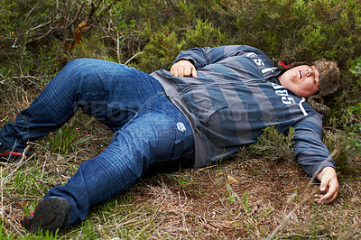 Buy stock photo Drunk, sleeping and hangover with a plus size man lying outdoor on the grass or ground after a party. Festival, alcohol and tired with a young male person asleep on a field or lawn in the morning