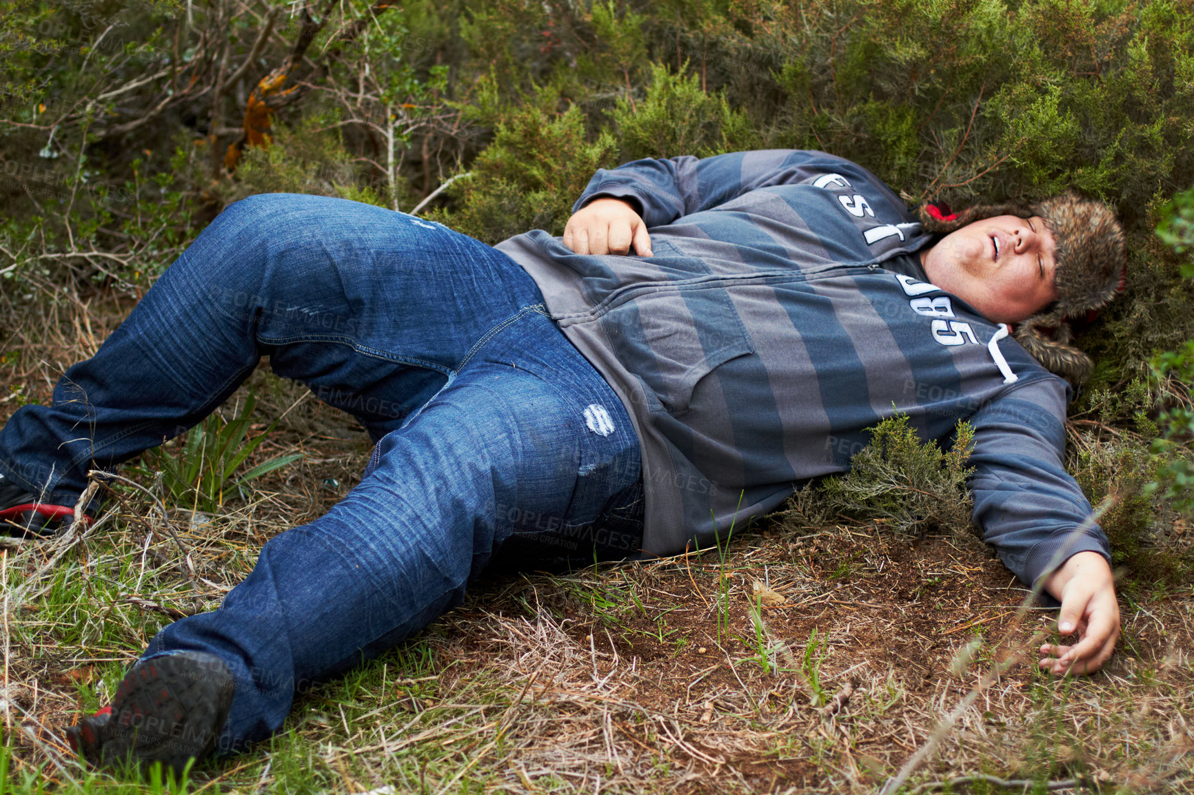 Buy stock photo Drunk, sleeping and hangover with a plus size man lying outdoor on the grass or ground after a party. Festival, alcohol and tired with a young male person asleep on a field or lawn in the morning