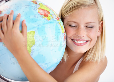 Buy stock photo A pretty young woman hugging a globe of the earth