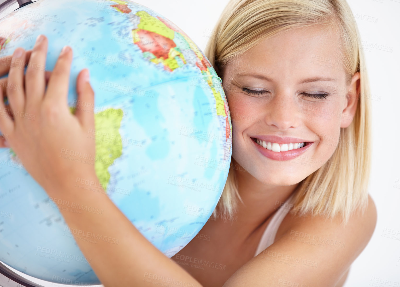 Buy stock photo A pretty young woman hugging a globe of the earth