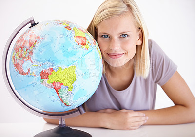 Buy stock photo Portrait, smile and globe for travel with a woman in studio on a white background for holiday destination. Face, earth or planet with a happy young person looking at a location for world vacation