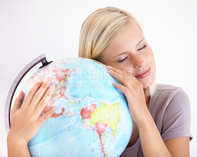 Buy stock photo A pretty young woman hugging a globe of the earth lovingly