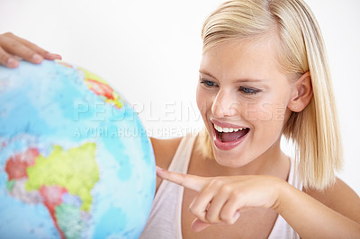 Buy stock photo Woman, travel and globe with point and happy from earth day, holiday or international vacation. Smile, world and map for learning and geography with a female person and destination on the planet