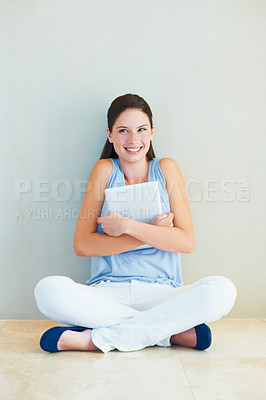 Buy stock photo Happy woman, tablet and sitting on floor for business, social media or communication at home. Young female person or freelancer smile against wall with technology for online networking at house