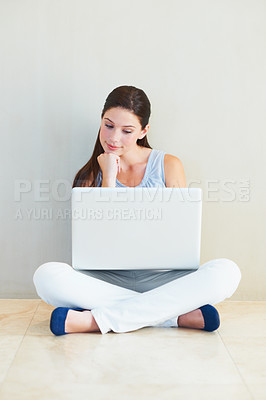 Buy stock photo Woman, laptop and thinking for idea, decision or choice sitting against a wall at home. Female person freelancer in wonder, thought or planning for online research or communication on floor at house