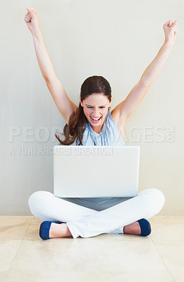 Buy stock photo A pretty young woman cheering while looking at her laptop screen