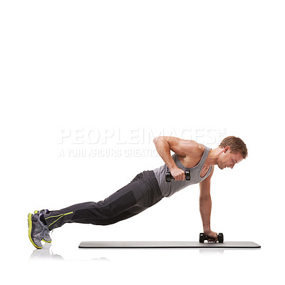 Buy stock photo A fit young man performing the row exercise with dumbbells on a mat