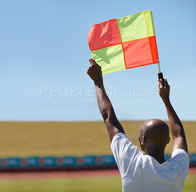 Buy stock photo Flag, foul and man soccer referee in football match or game wave to stop play during sport training or workout. Hand, sports and person or assistant official raise or signal mistake in sky background