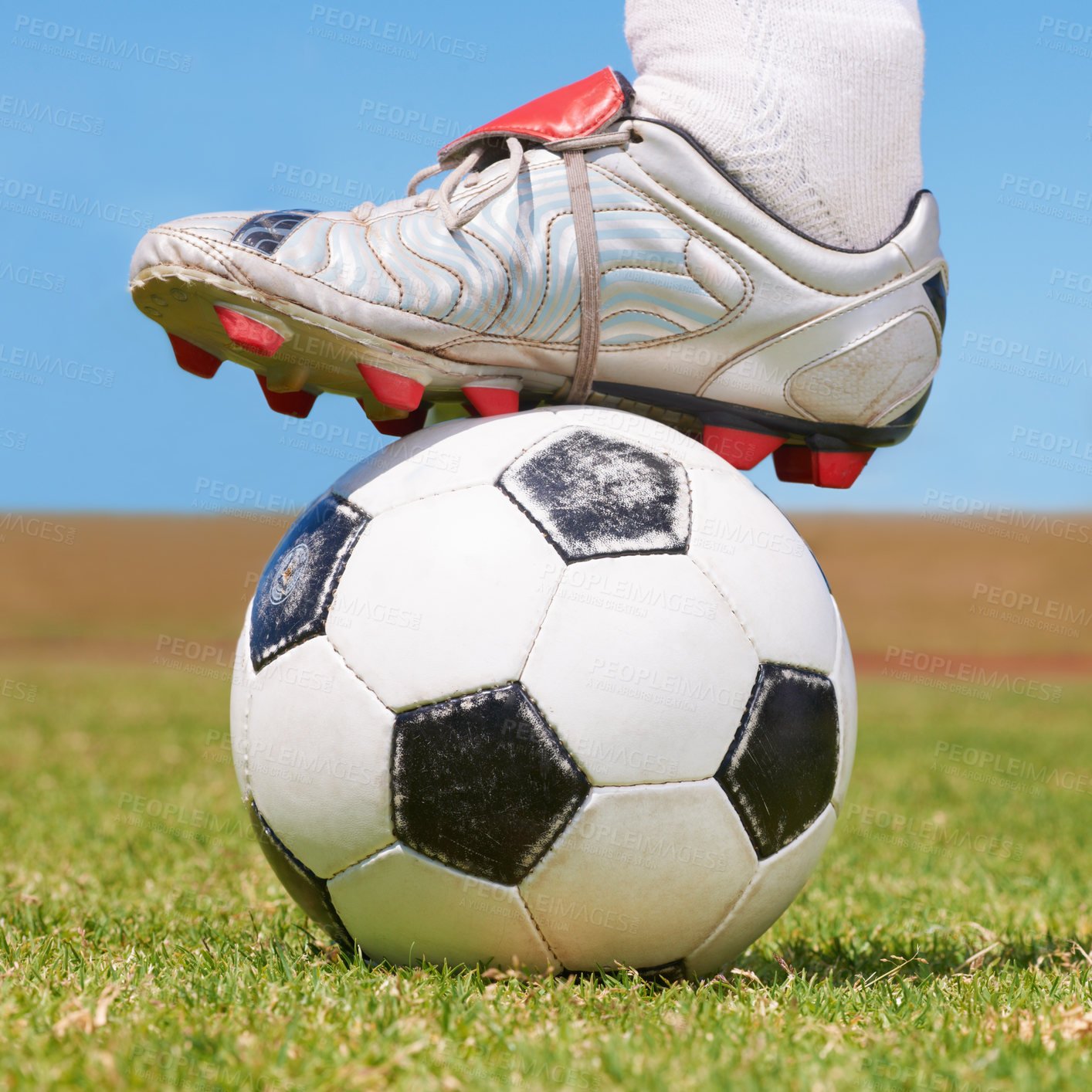 Buy stock photo Cropped closeup of a soccer boot resting on a soccer ball