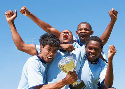 Buy stock photo A victorious soccer team cheering with their trophy