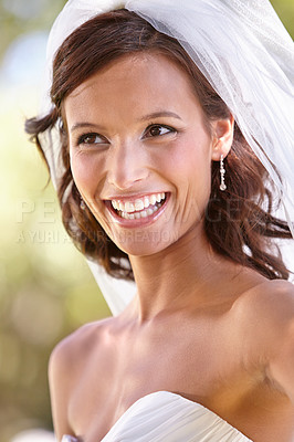 Buy stock photo Gorgeous young bride looking away in her wedding dress and veil