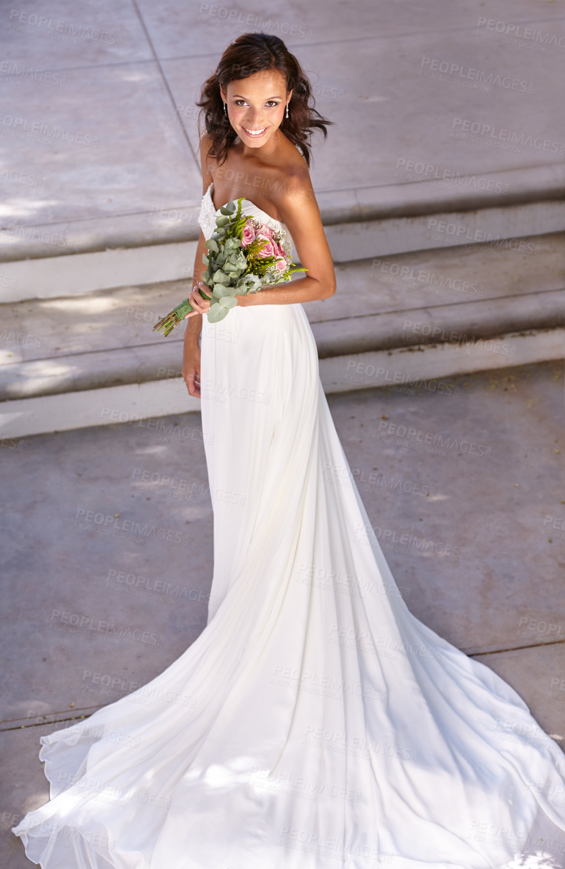 Buy stock photo Beautiful young bride holding her bouquet