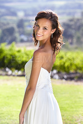 Buy stock photo Gorgeous young bride outdoors in her wedding dress
