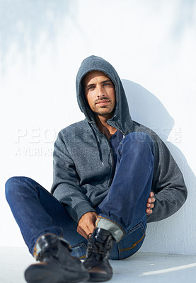 Buy stock photo Fashion, serious and portrait of man by a wall with casual, cool and stylish outfit with confidence. Handsome, young and young male person with trendy style with jeans and hoodie by white background.