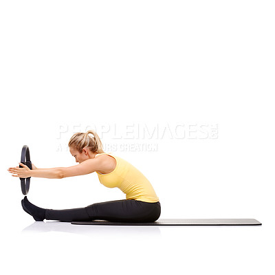 Buy stock photo A pretty young blonde performing the "roll up" exercise with her pilates ring