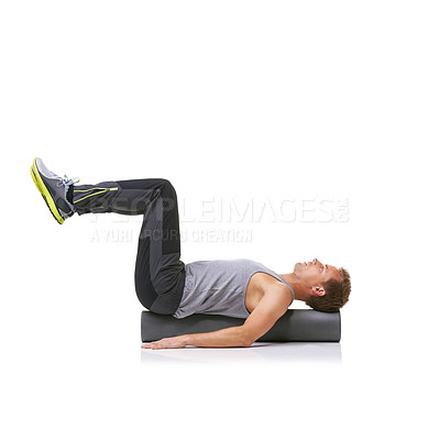 Buy stock photo Workout, foam roller and man in pilates back exercise, legs stretching or stability for sports rehabilitation, wellness or recovery. Floor, mockup space and studio athlete balance on white background