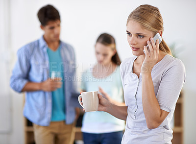 Buy stock photo Businesswoman, phone call and drinking coffee, networking and communication on technology in office. Female person, tea and speaking on smartphone in workplace, colleagues and teamwork or internet