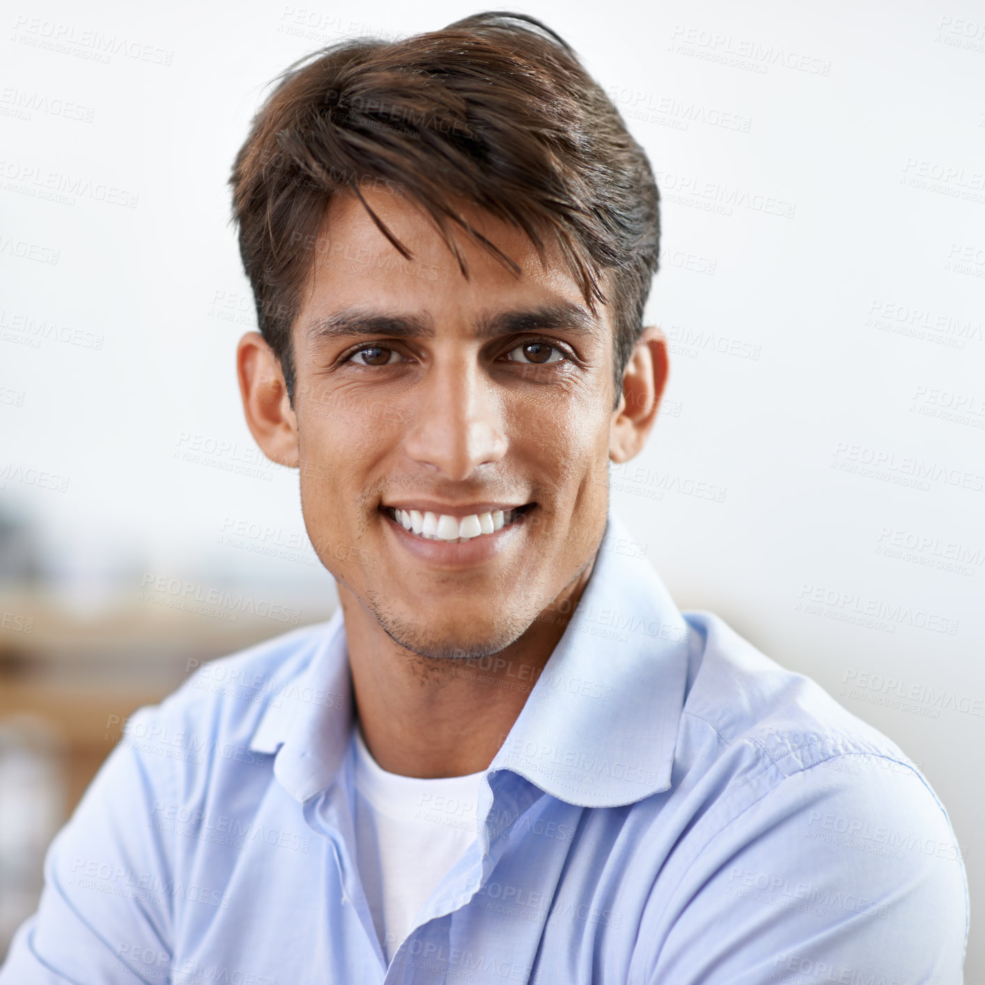 Buy stock photo A handsome young smiling businessman