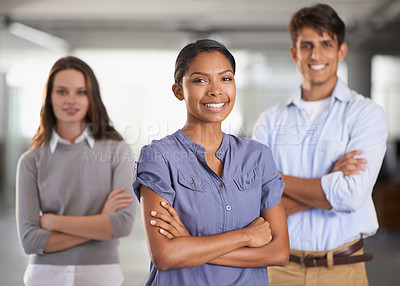 Buy stock photo A young business team standing with arms folded
