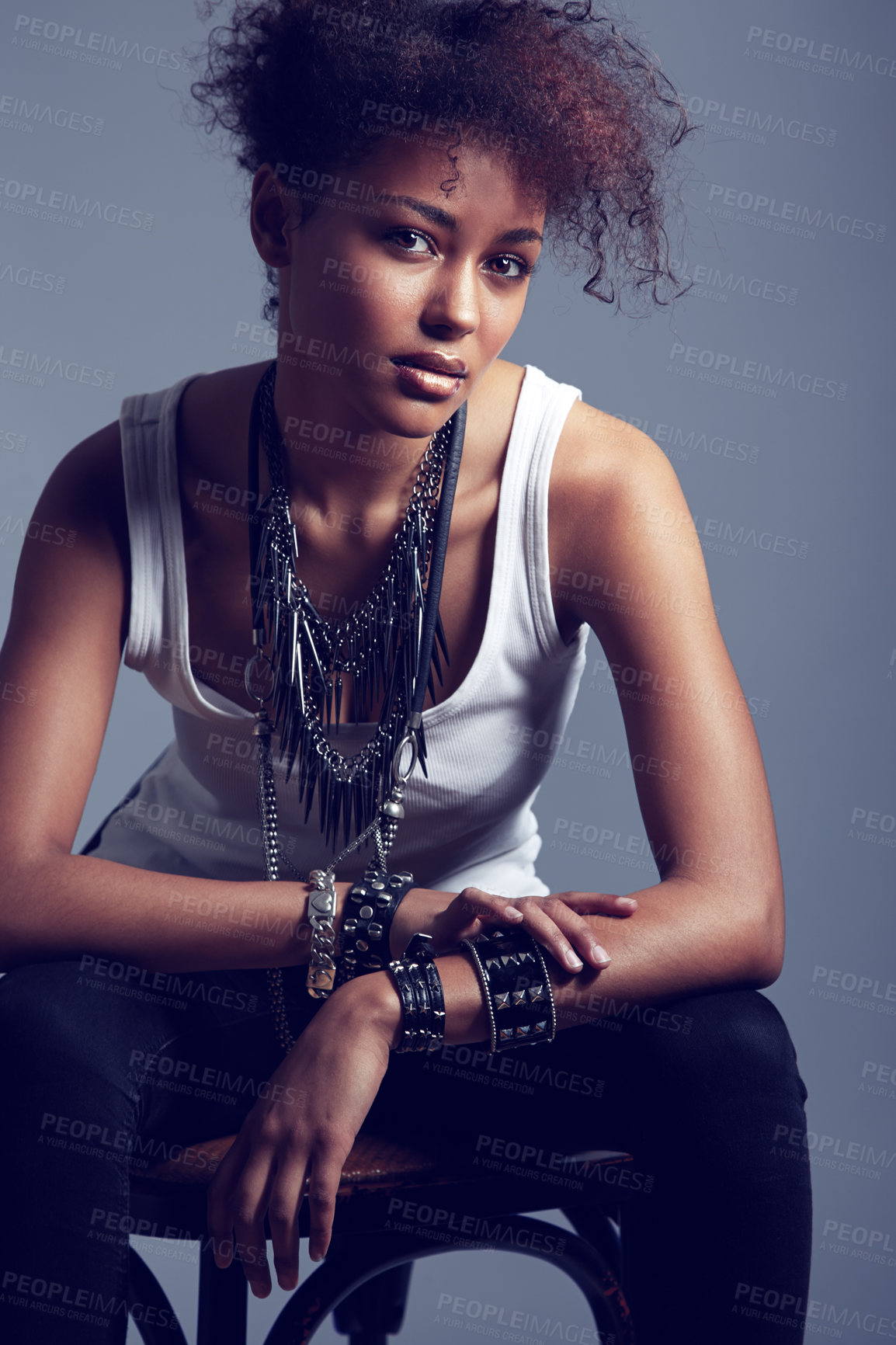 Buy stock photo A trendy young woman sitting on a chair