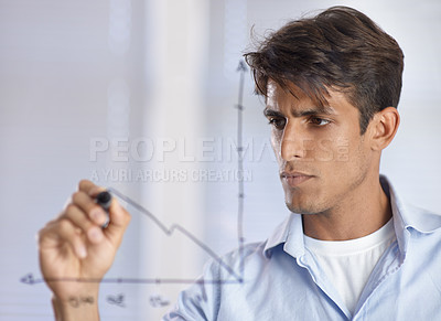 Buy stock photo A handsome young ethnic businessman drawing a graph on a glass wall
