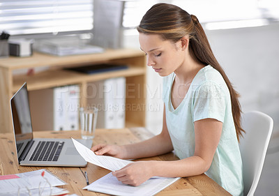 Buy stock photo Business woman, reading documents and planning on laptop for research, review and human resources management in office. Young worker with paperwork, contract analysis and computer for job information