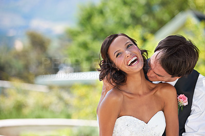 Buy stock photo Love, couple kiss on neck at wedding and marriage in nature together, smile or romance. Man, woman or bride, groom and laugh outdoor, commitment and connection in relationship, celebration or event