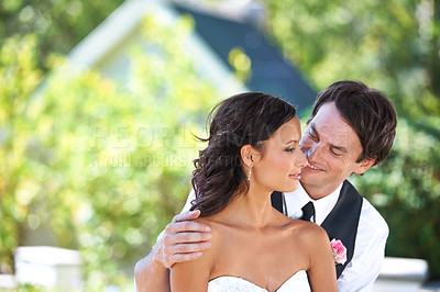 Buy stock photo An affectionate bridal couple embracing on their wedding day