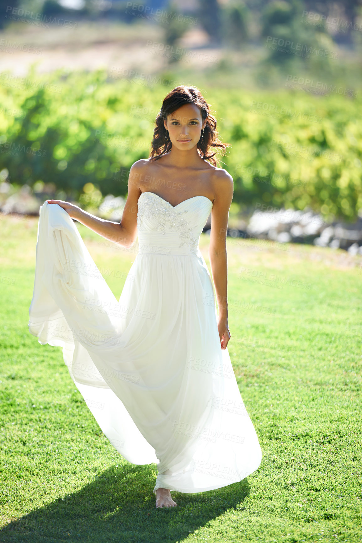 Buy stock photo Portrait, wedding dress and woman in nature, grass and outdoor for marriage. Bride holding gown, young person barefoot in countryside and beauty, fashion or stylish elegance in summer on lawn at park