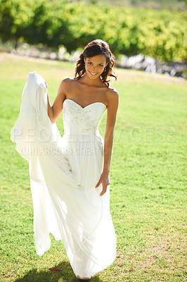 Buy stock photo A beautiful bride standing in front of a vineyard